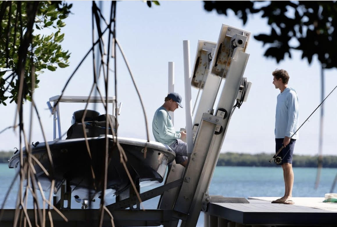 A lifestyle image from Fish Hippie showing two men with their fishing boat. 