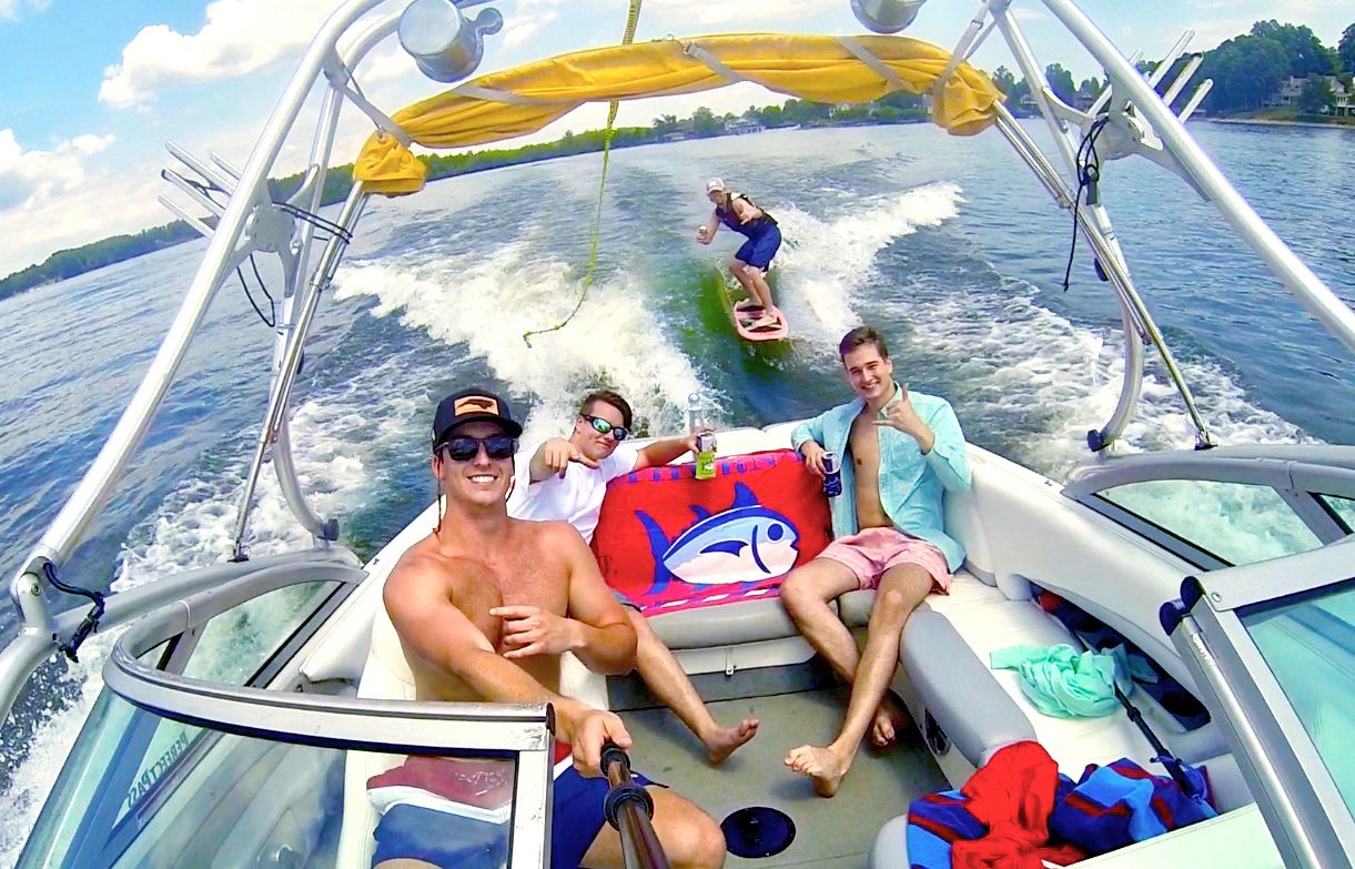 A lifestyle image from SOuthern Tide showing young people on a motor boat