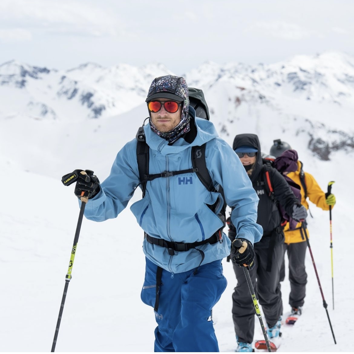 A lifestyle image from Helly Hansen showing a group of people trekking through the snow. 